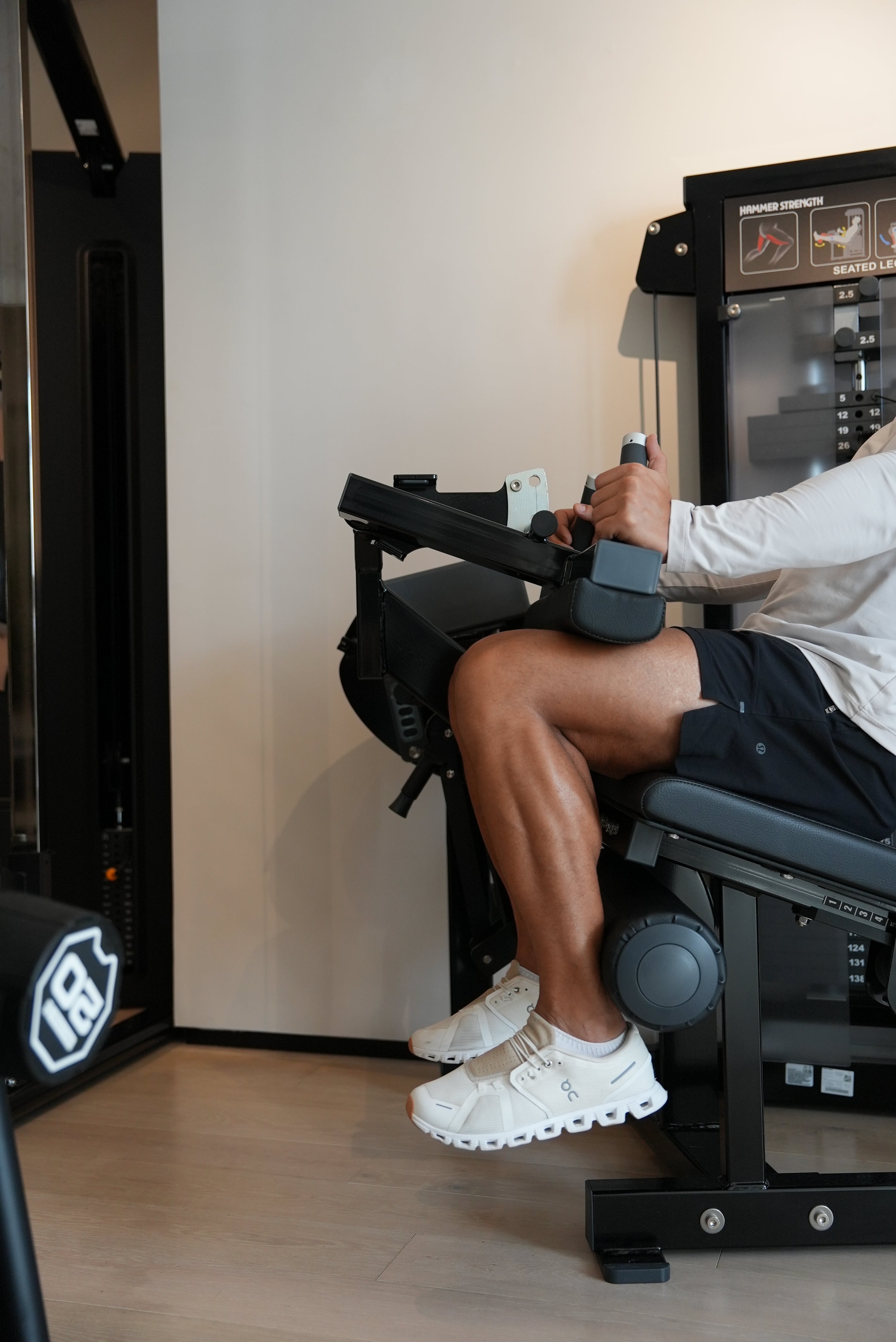 Male exercising using a top quality leg extension machine in private members only gym in Dubai.