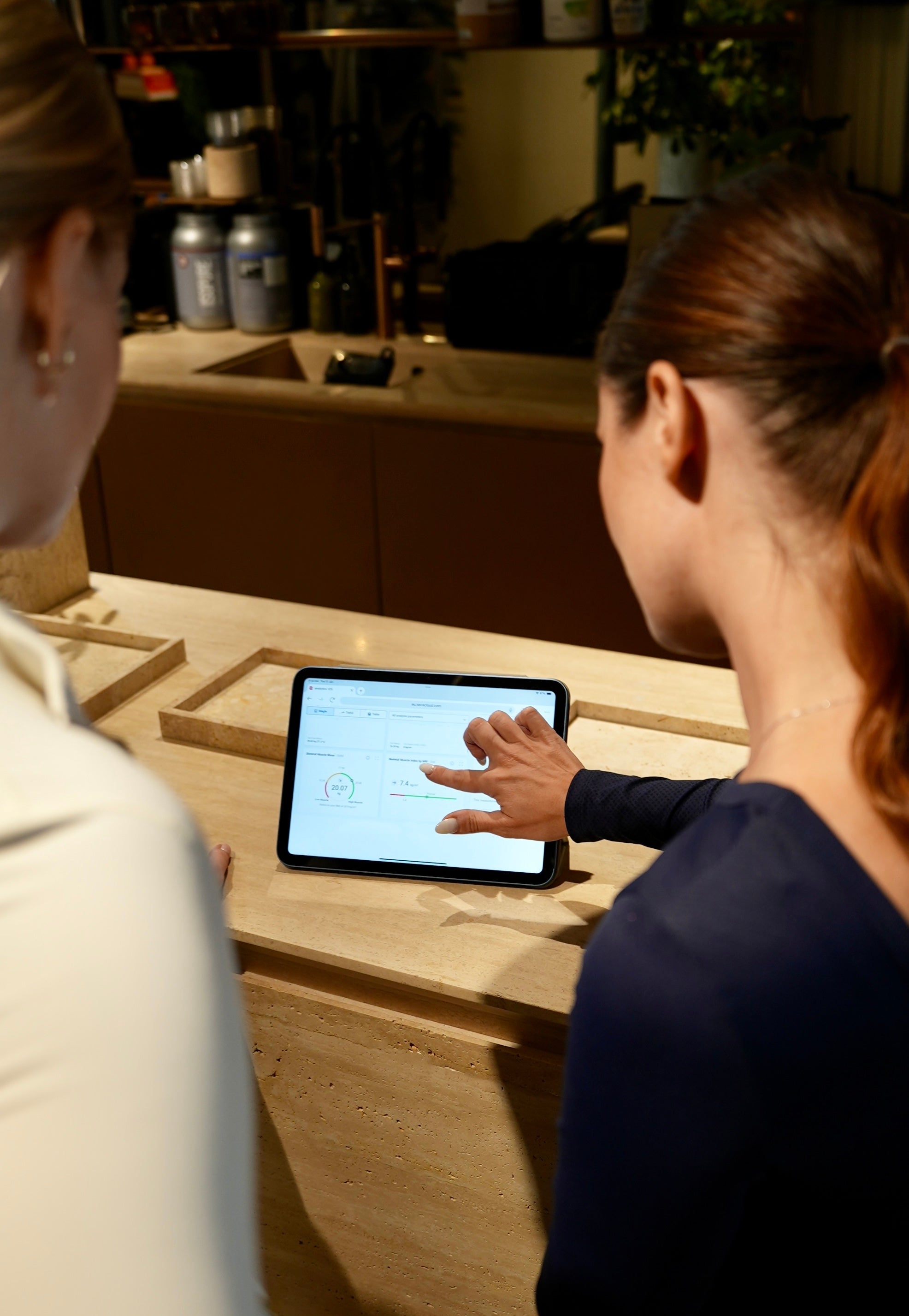 Personal trainer tracking clients progress to achieve their fitness goals.