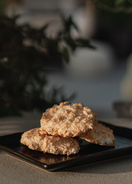 Three coconut macaroons served outside on a black tray. From Halm Cafe menu, Jumeirah, Dubai.