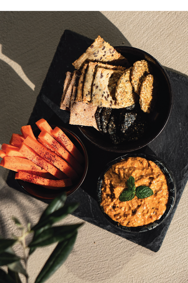 Vegan cheese dip with shawarma vibes. Cashew nuts, tofu, grilled red pepper served with Scandinavian sourdough rye thins. From the Halm Cafe menu, Jumeirah, Dubai.