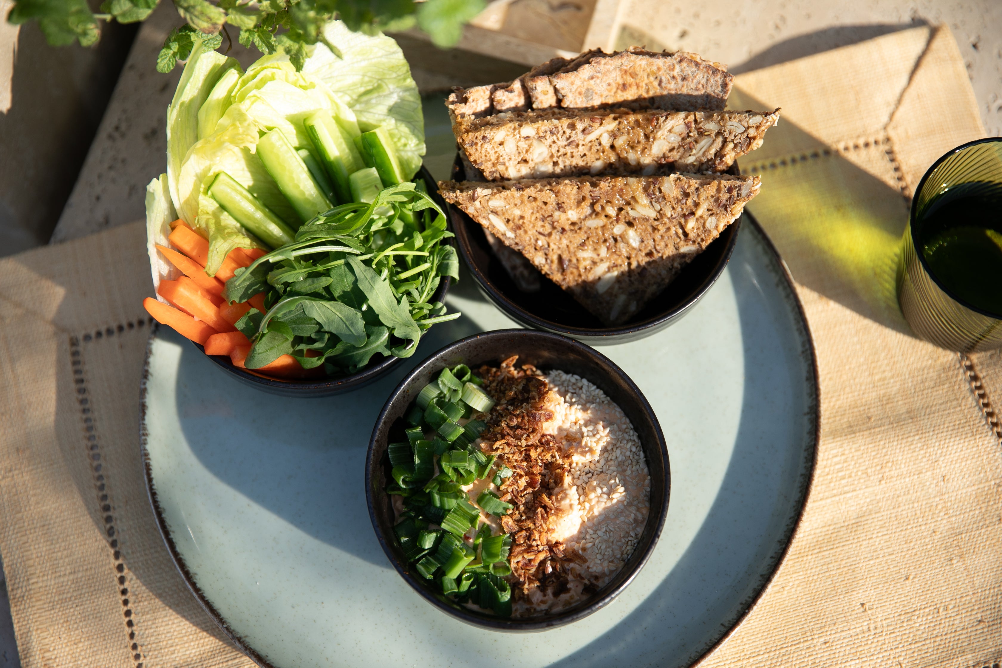 Healthy post-gym chicken bowl with healthy carrots, cucumber, lettuce abd bread. 
